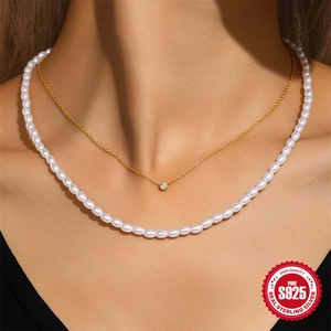Elegant double-layered S925 silver necklace with zircon pendant and pearls on a model