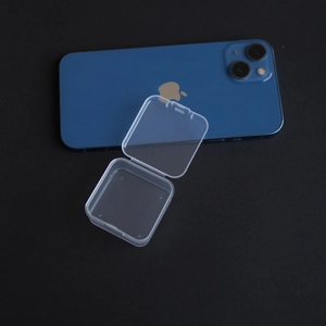 Compact clear PP storage case shown next to a smartphone for size reference