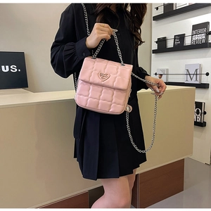 Pink quilted chain bag with heart-shaped metal buckle and elegant leather texture detail