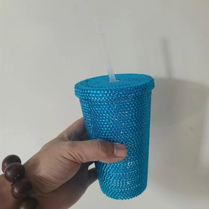Detailed close-up of blue studded double-wall tumbler with matching straw and texture