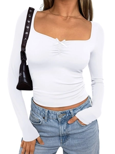 Close-up of white long-sleeve top with square neckline and delicate bow detail