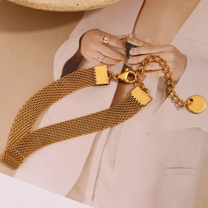 Detailed macro view of 18K gold-plated stainless steel mesh bracelet with lobster clasp