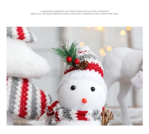 Detailed view of plush Christmas snowman ornament with knitted hat and pinecone decor
