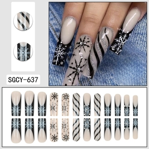 Christmas coffin press-on nails with black snowflakes, silver glitter, and rhinestone accents