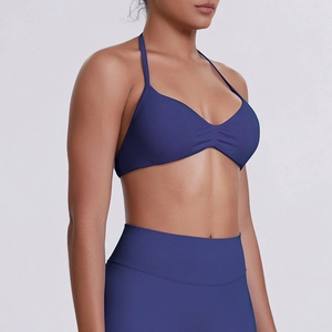 Detailed side view of high-elastic halter sports bra with ruching and high waist leggings