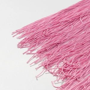 Close-up of vibrant pink tassel fringe details with high-quality silk thread textures