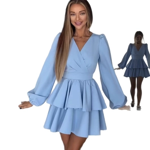 Detail of light blue V-neck dress with long sleeves and tiered ruffled mini skirt