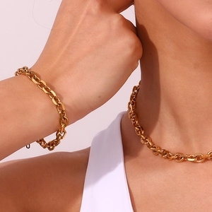 Detail shot of model wearing the 18K gold plated stainless steel chain necklace and bracelet set