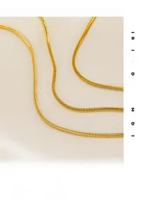 Macro shot of 18K gold plated snake chain texture with smooth metallic finish