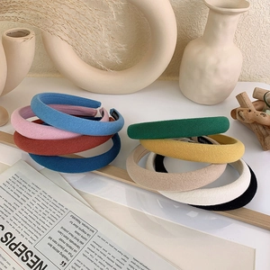 Detailed macro view of assorted colorful sponge headbands with handmade tags