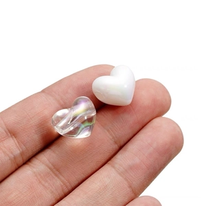 Iridescent heart-shaped beads in transparent and white colors for DIY jewelry crafting