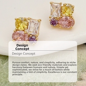 Detail view of colorful zircon studs with gold finish and asymmetric multi-stone setting