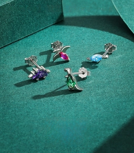 Detail of S925 sterling silver dinosaur studs with colorful pear-cut zircon stones