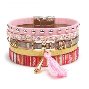 Macro detail of Bohemian multilayer bracelet with pink suede, sequins, and magnetic clasp