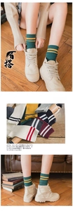 Detailed close-up of striped combed cotton socks in multiple retro color block patterns
