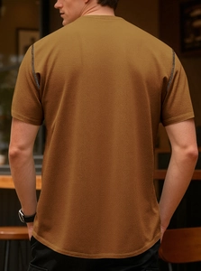Detailed back view of tan waffle knit polo shirt showing textured fabric and slim fit
