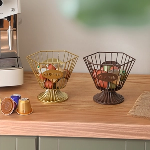 Nordic gold and brown metal coffee pod storage basket with hexagon grid on wood table