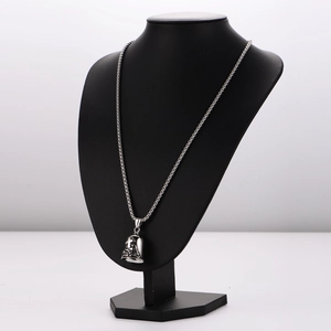 Vintage stainless steel cross bell pendant necklace displayed on a black neck bust model