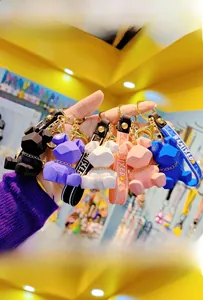Five colorful resin geometric bunny keychains with matching wrist straps and gold hardware