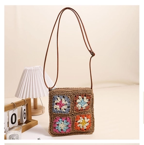 Detailed macro shot of vintage hollow flower woven straw bag with colorful crochet patterns