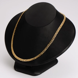 Minimalist gold textured nugget chain necklace displayed on a black velvet mannequin bust