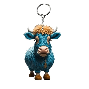 Detailed close-up of blue Highland cow keychain with orange hair and golden medal