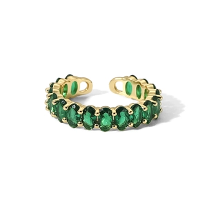 Close-up of golden adjustable ring with oval green cubic zirconia stones on white background
