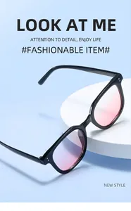 Side view of black oversized sunglasses with pink gradient lenses on a display stand