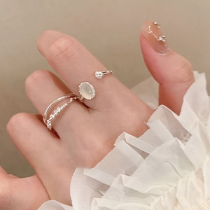 Silver oval resin open ring set with minimalist aesthetic on a female hand model