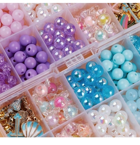 Macro shot of green beads set in clear organizer for DIY jewelry and crafts making