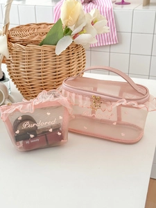 Pink mesh makeup bag set with ruffled lace edges and star-shaped zipper pulls