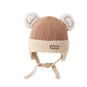 Toddler knitted winter hat with cute pompom bear ears and warm earflaps in khaki color