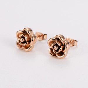 Detail view of 3D rose flower stud earrings in rose gold finish with metal backings