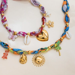 Colorful ocean-themed fabric necklaces with gold charms like shells, starfish and hearts