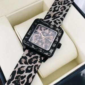 Close-up of square leopard print watch with black case in a beige jewelry gift box