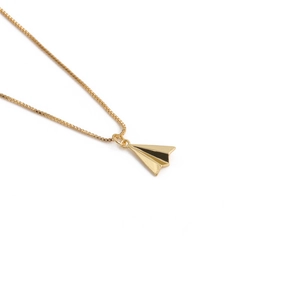 Minimalist gold paper plane pendant necklace for women on a clean white background