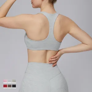 Women's heather grey racerback sports bra and high-waist yoga leggings set from the back