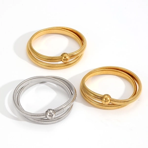 Detail of magnetic opening stainless steel bangles with textured coil and ball beads