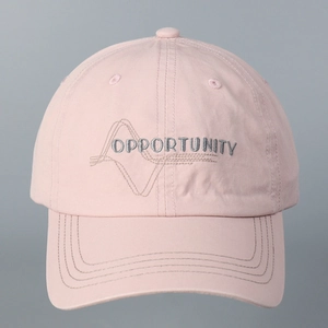 Detail of pink cotton baseball cap featuring gray OPPORTUNITY embroidery and stitching