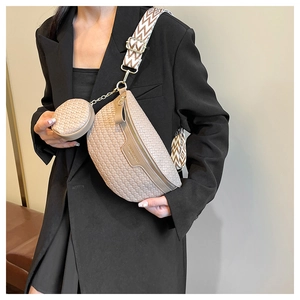 Detail of beige woven crossbody bag with geometric strap and round coin purse accessory