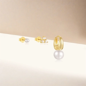 Detail of S925 silver pearl earring set featuring star studs and gold hoops