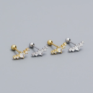 Detailed view of silver and gold curved stud earrings with inlaid sparkling cubic zirconia