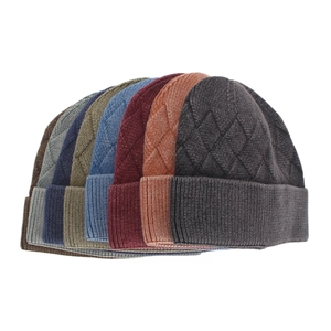 Close-up of thick core-spun yarn beanies in seven colors with ribbed knit texture