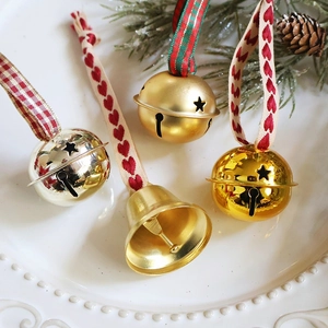 Champagne gold Christmas bell ornament with red heart ribbon and festive pine cone decor