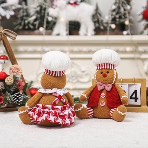 Pair of large sitting gingerbread plush toys in festive outfits for Christmas home decor