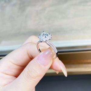 Macro shot of 925 sterling silver ring featuring a round moissanite with halo setting