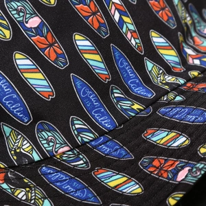 Detail of twill fabric bucket hat with flamingo print and 'The Ocean is Calling' text