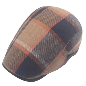 Detail of colorful plaid flat cap with adjustable strap in vintage British style