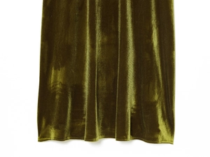 Close-up detail of the olive green velvet fabric and hemline of the dress