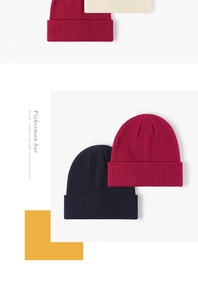 Detailed close-up of ribbed texture on wine red, cream, and navy knit beanies